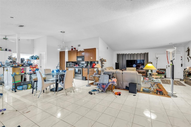 dining area featuring ceiling fan, light tile patterned floors, and a textured ceiling