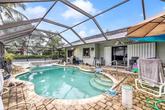 view of swimming pool with a patio and a lanai