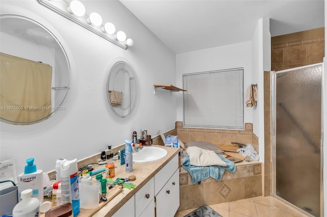 bathroom with tile patterned floors, separate shower and tub, and vanity