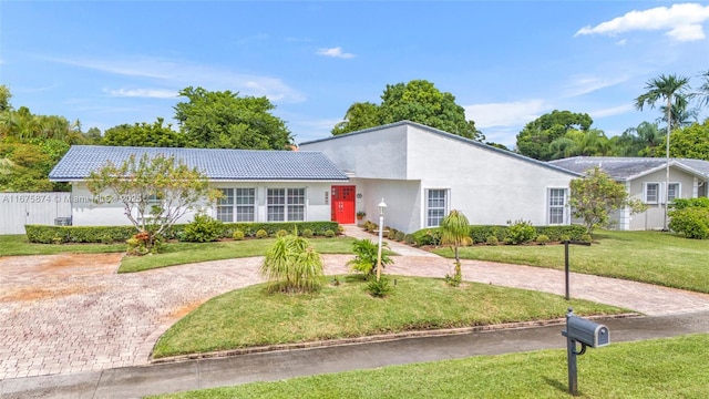 ranch-style house with a front lawn