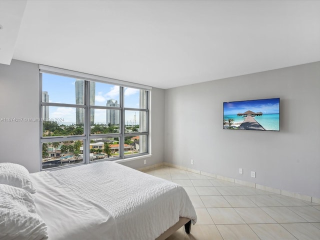 bedroom with light tile patterned flooring and multiple windows