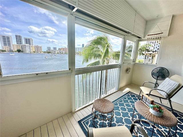 sunroom featuring a water view