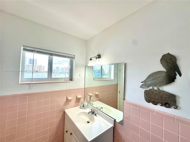 bathroom with vanity and tile walls