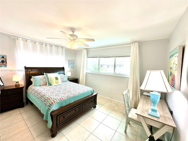 bedroom with ceiling fan and light tile patterned floors