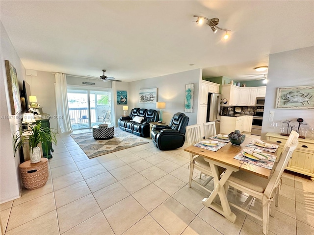 tiled dining space with ceiling fan