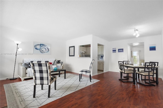 dining space featuring hardwood / wood-style floors and a textured ceiling