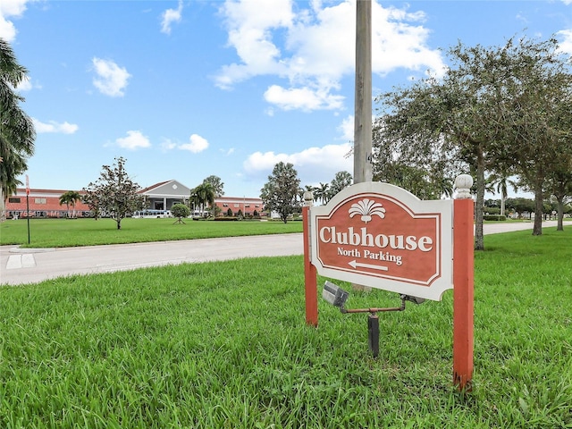 community / neighborhood sign with a lawn