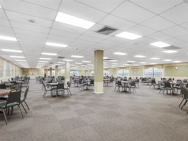 dining area featuring carpet floors and a paneled ceiling