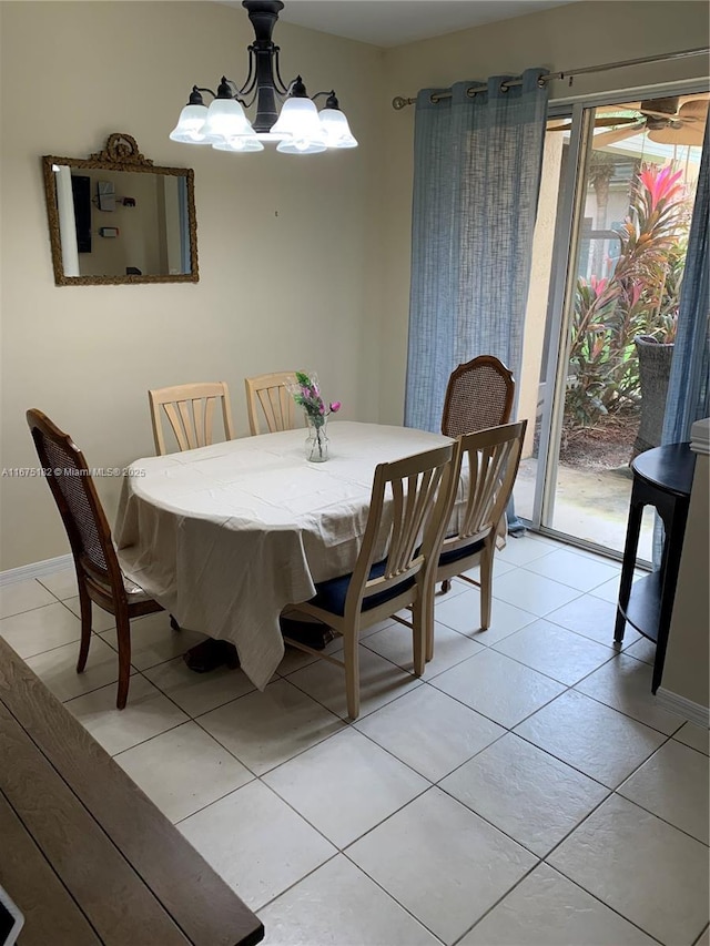 tiled dining area featuring a chandelier