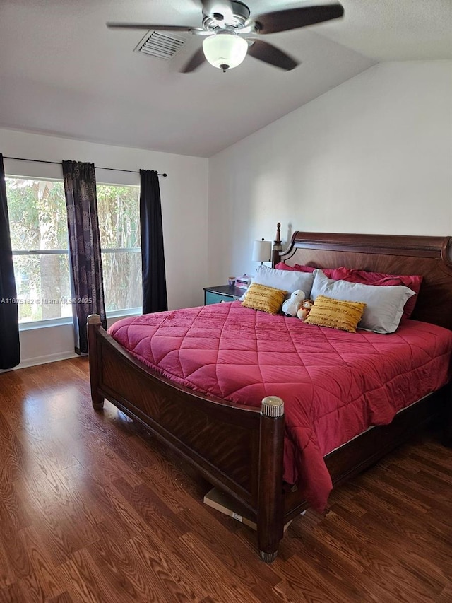 bedroom featuring ceiling fan, dark hardwood / wood-style flooring, and vaulted ceiling