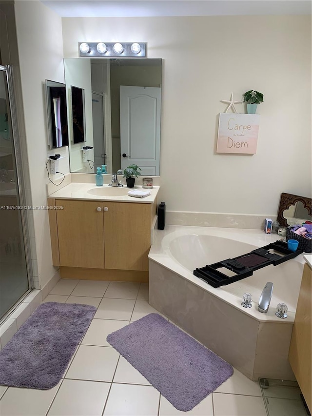 bathroom with tile patterned flooring, vanity, and shower with separate bathtub