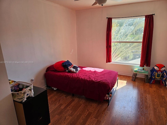 bedroom featuring ceiling fan and dark hardwood / wood-style floors