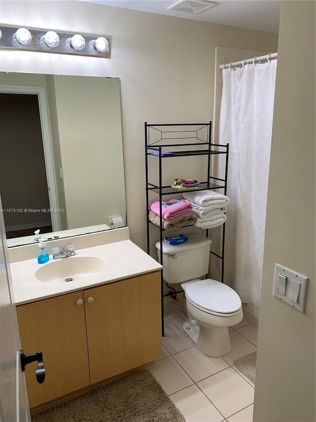 bathroom with tile patterned floors, vanity, toilet, and a shower with curtain