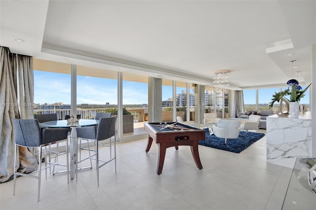 recreation room with pool table, a wealth of natural light, and floor to ceiling windows