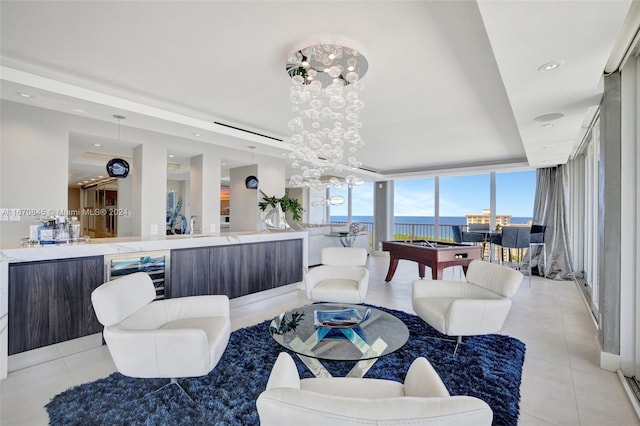 living room featuring a water view, beverage cooler, a wall of windows, billiards, and light tile patterned floors