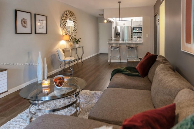 living area featuring dark wood-type flooring and baseboards