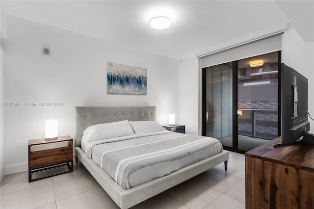 bedroom with access to outside and light tile patterned floors