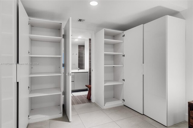 1010 Brickell Ave Unit 1607, Miami, FL 33131 - spacious closet featuring a sink and light tile patterned flooring