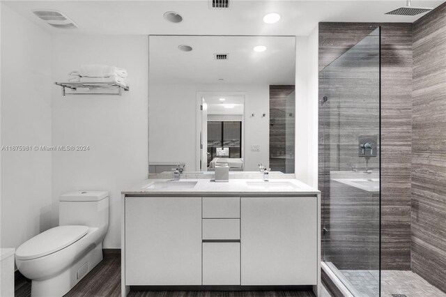 1010 Brickell Ave Unit 1607, Miami, FL 33131 - full bath with visible vents, a sink, a tile shower, and toilet