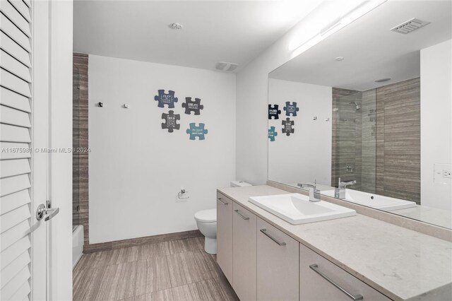 1010 Brickell Ave Unit 1607, Miami, FL 33131 - full bath with toilet, baseboards, visible vents, and vanity