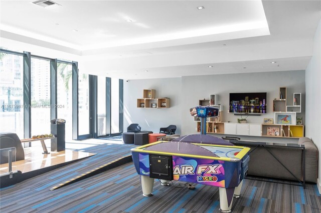 1010 Brickell Ave Unit 1607, Miami, FL 33131 - rec room featuring visible vents, carpet, and a tray ceiling