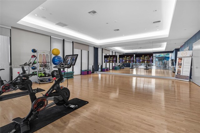 1010 Brickell Ave Unit 1607, Miami, FL 33131 - gym featuring visible vents, a raised ceiling, and wood finished floors