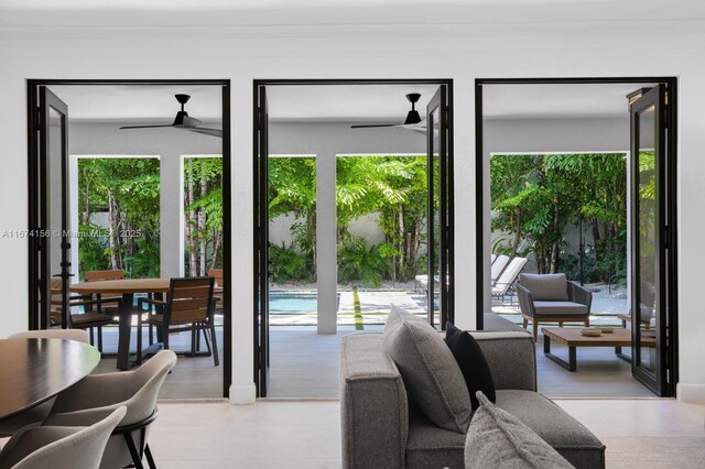 back of house with an outdoor living space, ceiling fan, and a patio area