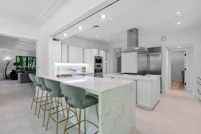 kitchen with extractor fan, white cabinetry, stainless steel appliances, crown molding, and light stone countertops