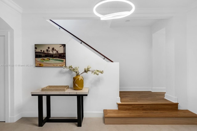 stairs featuring crown molding