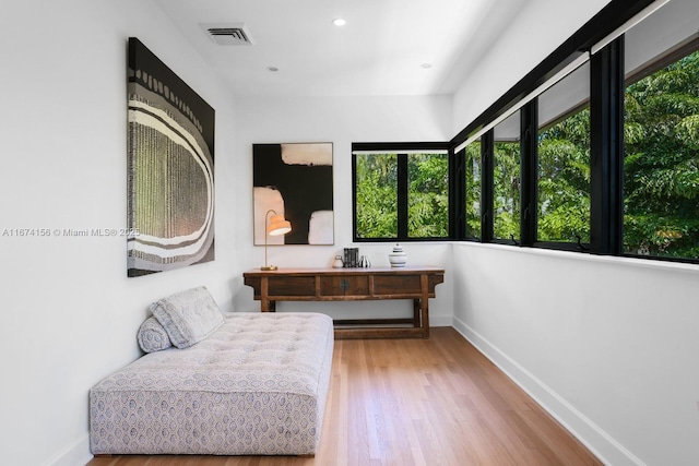 living area featuring hardwood / wood-style floors and a healthy amount of sunlight