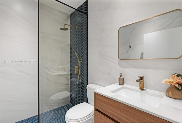 bathroom featuring tile walls, vanity, toilet, and tiled shower