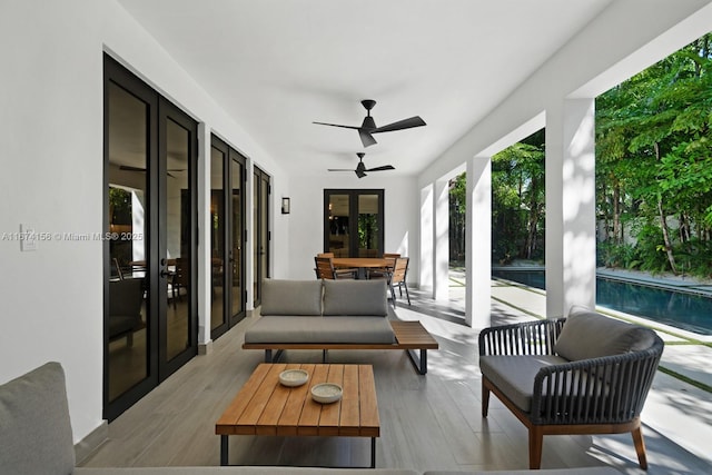 sunroom / solarium with french doors and ceiling fan