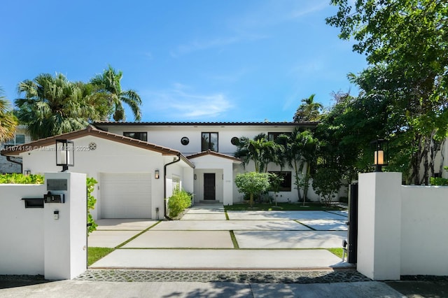 mediterranean / spanish-style house with a garage