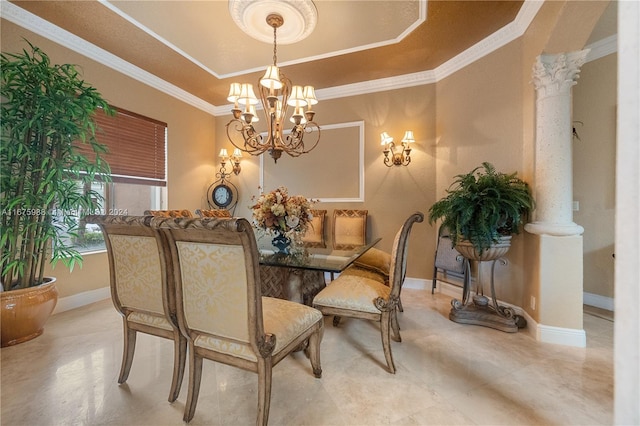 dining space featuring crown molding, a notable chandelier, a tray ceiling, and decorative columns