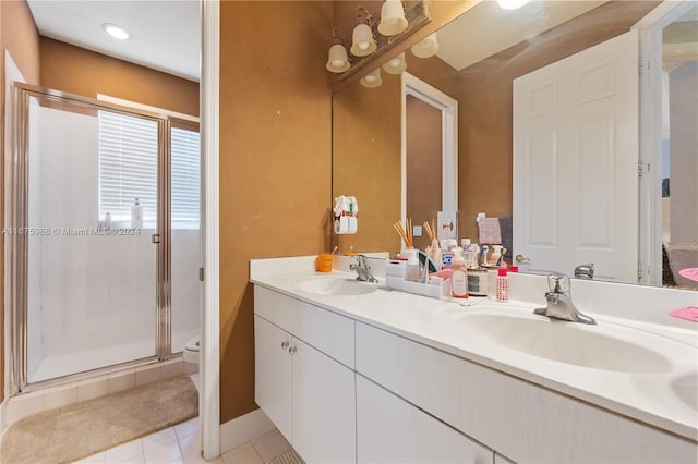 bathroom with vanity, toilet, walk in shower, and tile patterned flooring