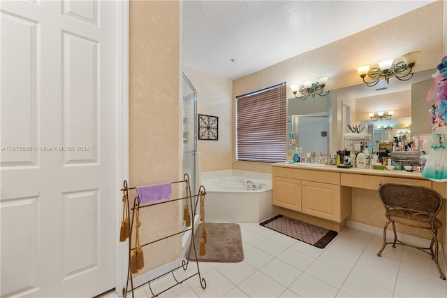 bathroom featuring vanity, separate shower and tub, a textured ceiling, and tile patterned flooring