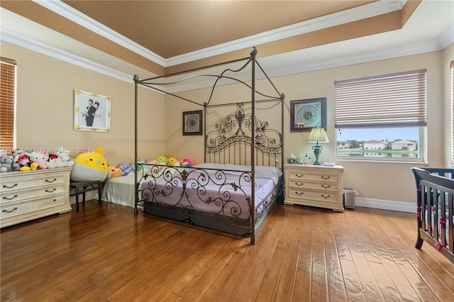 bedroom featuring ornamental molding and light wood-type flooring