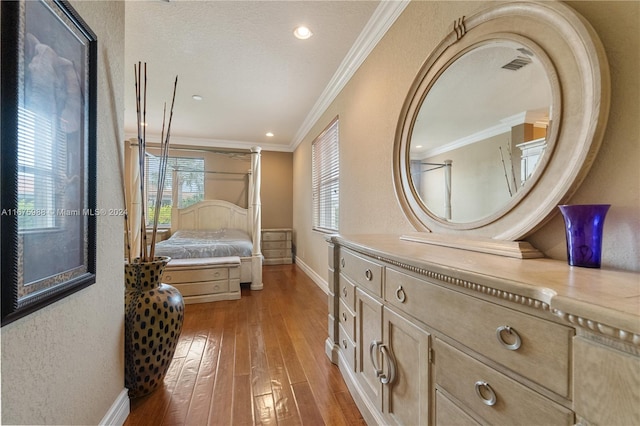 bedroom featuring ornamental molding, a textured ceiling, and light wood-type flooring