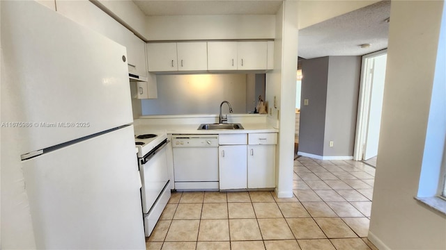 kitchen with a textured ceiling, white appliances, sink, light tile patterned floors, and white cabinetry