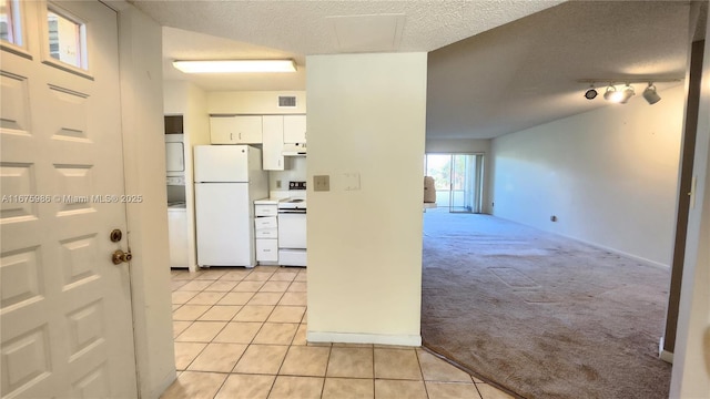 kitchen with light carpet, rail lighting, white appliances, a textured ceiling, and white cabinets