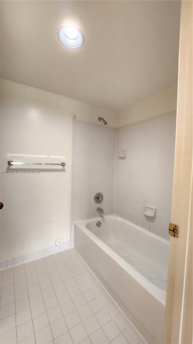 bathroom with tile patterned flooring and tiled shower / bath combo