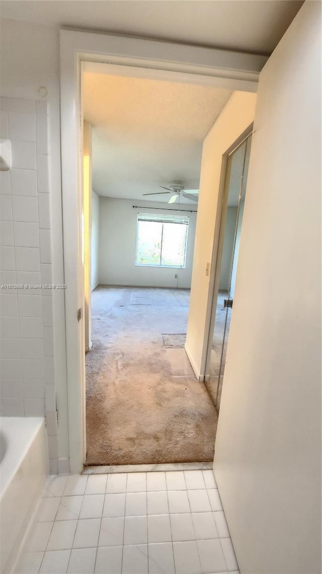 hallway featuring light colored carpet