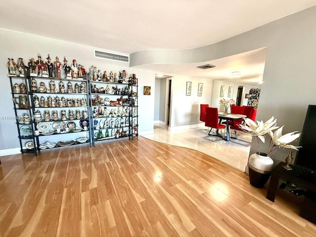 wine cellar with hardwood / wood-style floors and bar area