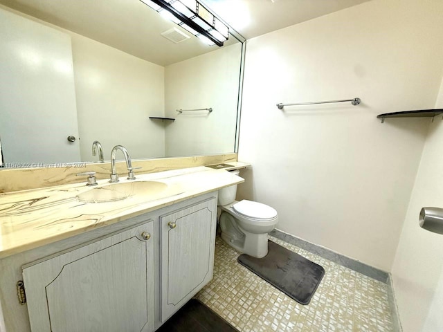 bathroom featuring vanity, toilet, and tile patterned floors