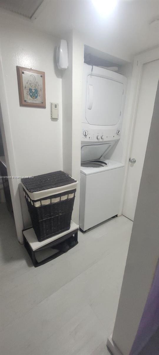 laundry room with stacked washer / drying machine