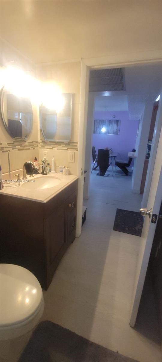 bathroom featuring vanity and toilet