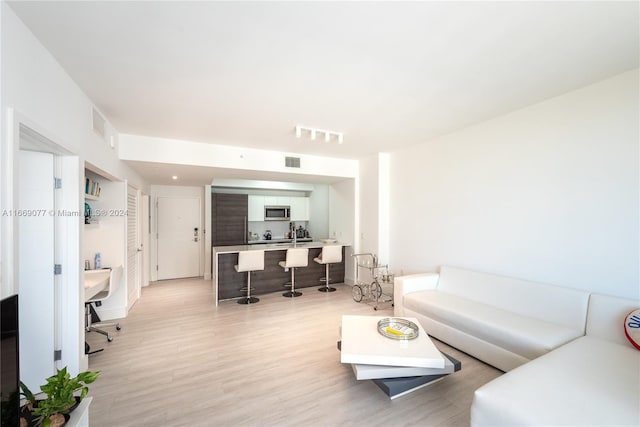 living room with light hardwood / wood-style flooring