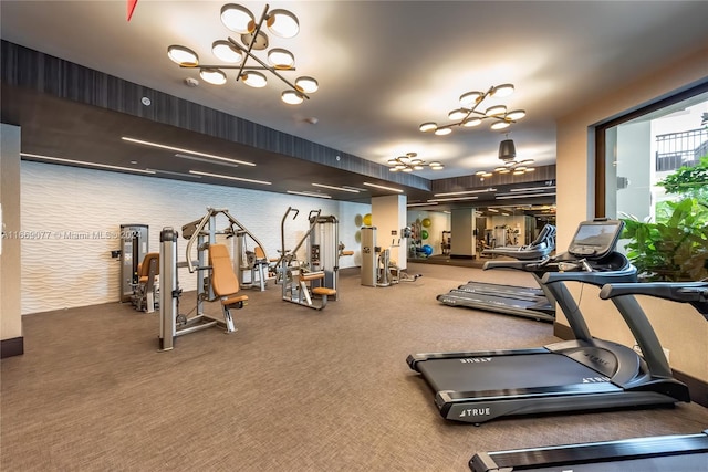 workout area with an inviting chandelier