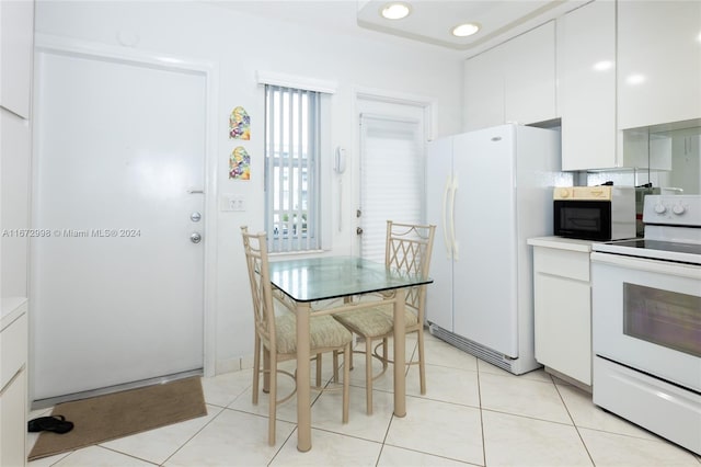 kitchen with white cabinetry, white appliances, and light tile patterned floors