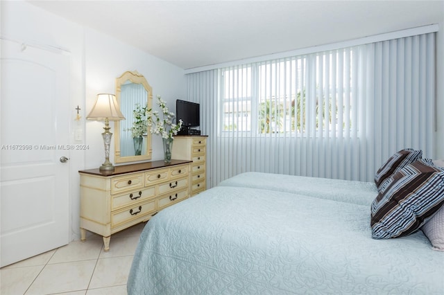 bedroom with light tile patterned floors